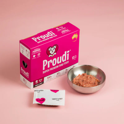 Proudi dog food packaging with a bowl of food on a pink background