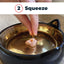 Step 2: squeezing Antinol oil onto cat food
