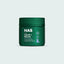 Green jar labeled 'NAS Cat Calm + Relax' on a light gray background