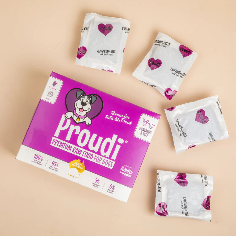 Proudi dog food packaging with multiple packets on a beige background